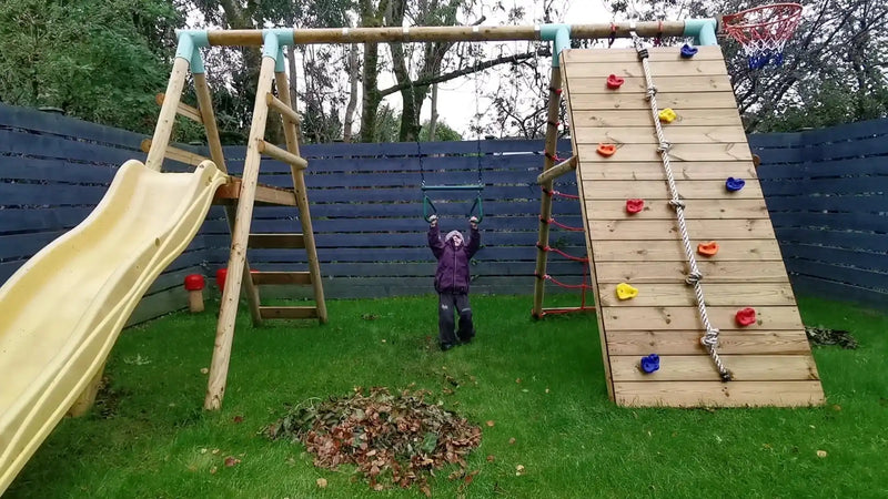 Autumn play on a garden wooden swing, climbing and slide set
