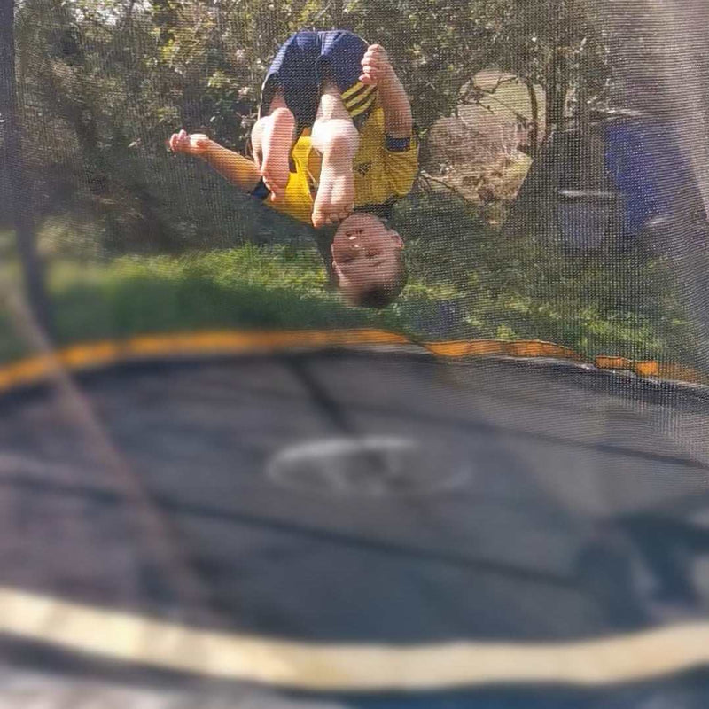 Boy doing tricks on 10ft trampoline