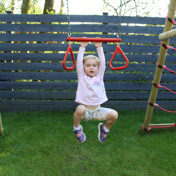 A girl swinging on a Go Wild Metal Trapeze Bar