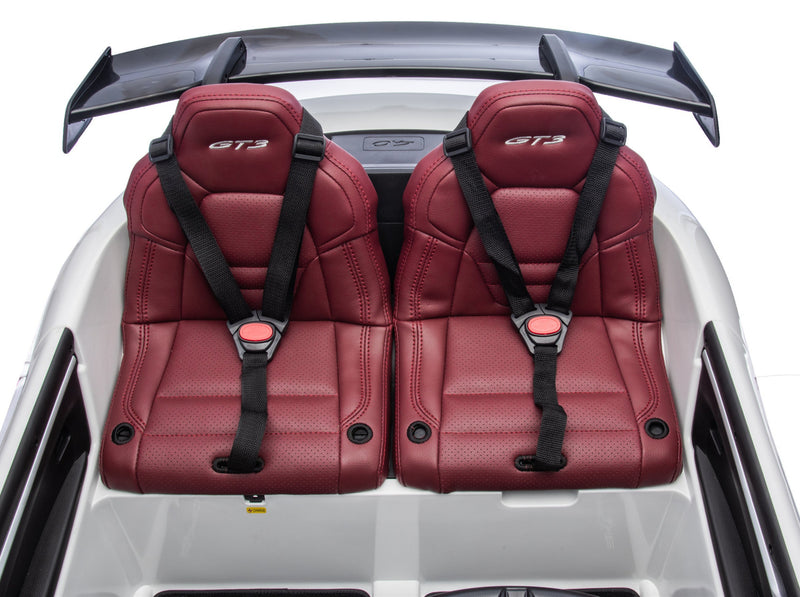 kids porsche 911 gt3 with Red car seats with black harnesses inside a vehicle on a white background