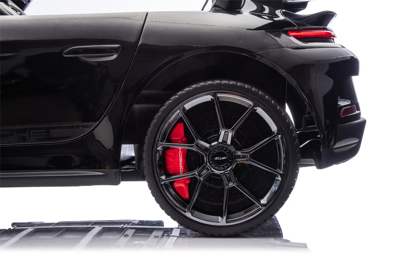 a black kids ride on toy porsche with 2 red leather seats 