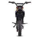 A rear view of a black off-road electric dirt bike with knobby tires, a rear rack, and a digital display on the handlebars, set against a plain white background.