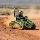 Person driving a green go-kart on a dirt track with a desert landscape in the background