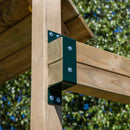 Wooden structure with green metal brackets against a blurred green background