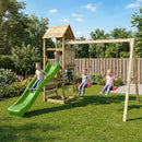 Children playing on a wooden playground set with a green slide in a garden.