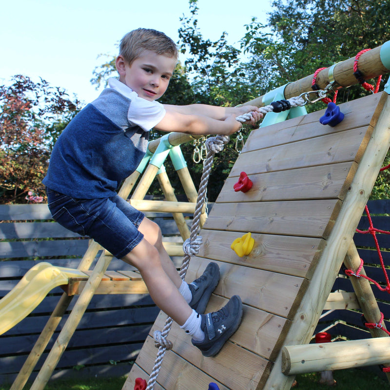 child using a climbing wall and rope 