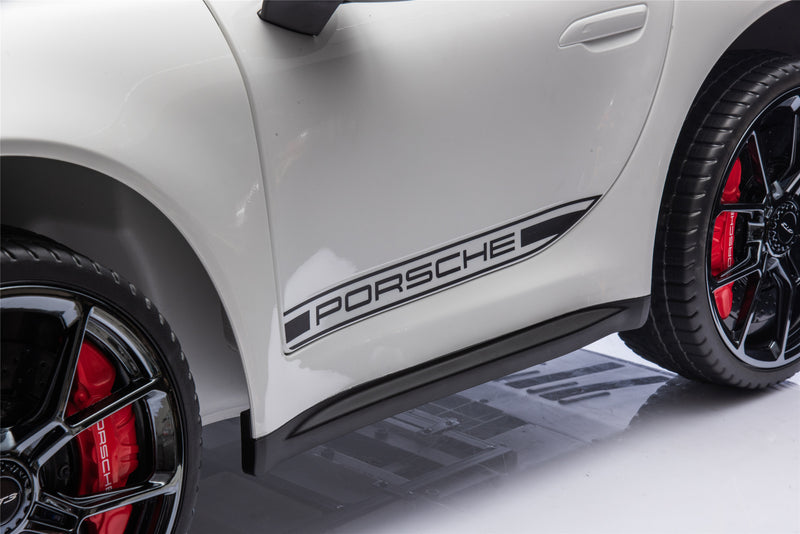 Close-up of a kids Porsche car side with visible branding.