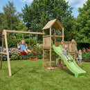 A wooden backyard playset with a swing set, climbing tower, and green slide, shown in a grassy garden with children playing under a blue sky.